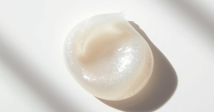Jar of eye cream on a bathroom shelf