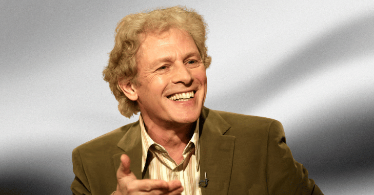 Paul Nicholas performing a song on stage